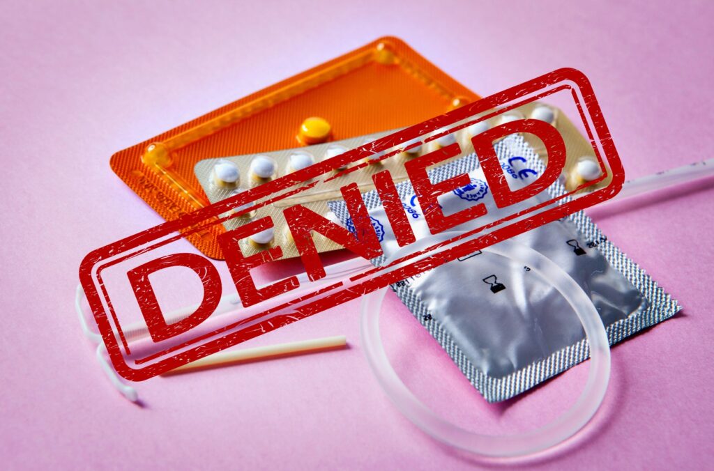 Image of birth control methods (pill, implant, ring) rubber stamped in red ink the word "Denied"